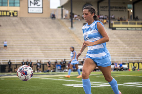 Soccer player Madison Hernandez chases after the ball.