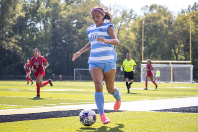 NPC soccer player, Madison Hernandez, kicks the ball down the field.