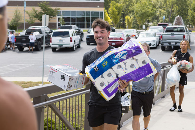 NPC Men’s Baseball players Josh Lumsden (center) and Que Walton (back) carrying belongings into Dogwood Hall during the fall move-in day.