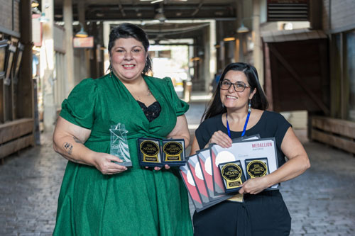 Melissa Kennon and Melony Martinez holding awards.