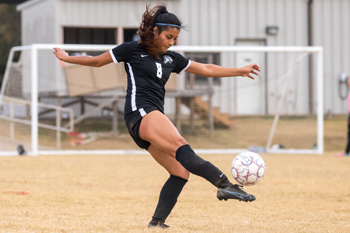 Kicking the soccer ball, number 8 Yessi Vargas.