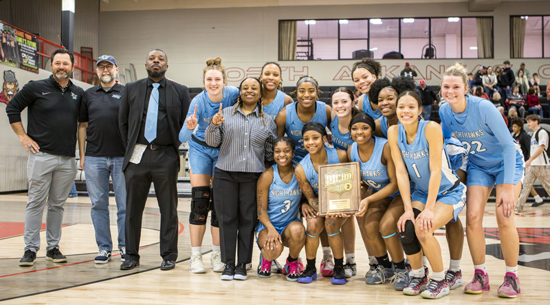 Group shot of the NPC women's basketball team with their coaches, NPC president and the athletics director.