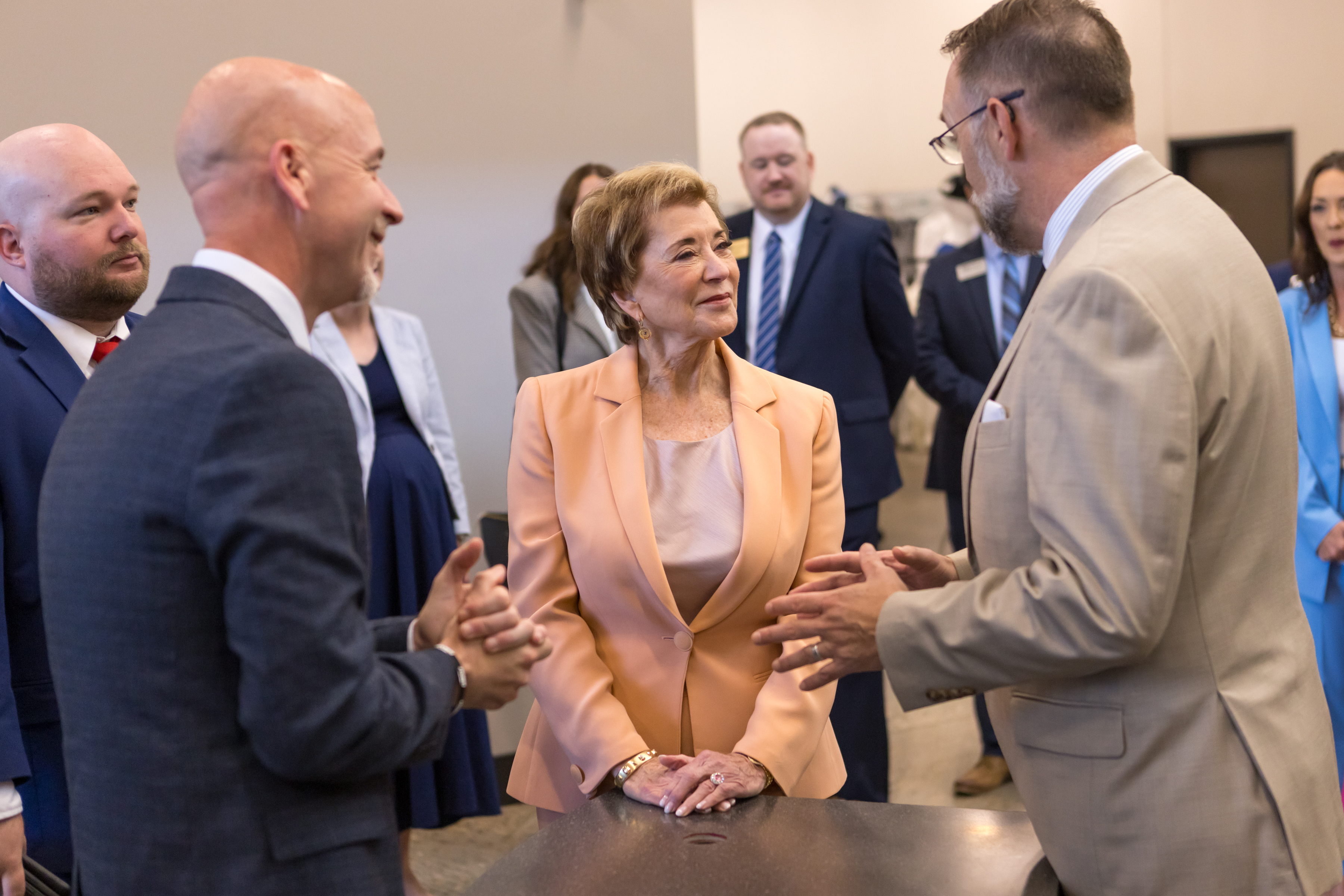 Arkansas Secretary of Education Jacob Oliva, U.S. Secretary of Education Linda McMahon and National Park College President Dr. Wade Derden speaking to each other.