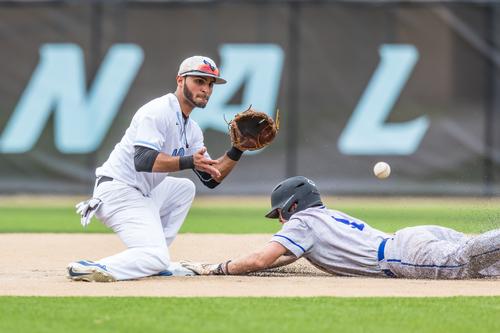 NPC baseball player holding out glove to catch ball while opponent slides into base.