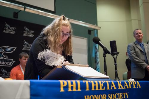 PTK inductee signing the membership book. 