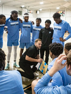 NPC Coach Dillon Hargrove giving the men's basketball team some direction during the game.