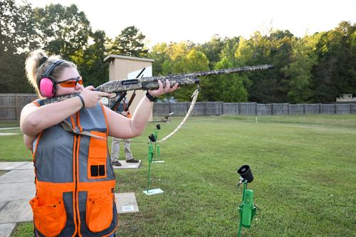 Female trap shooter holding rifle